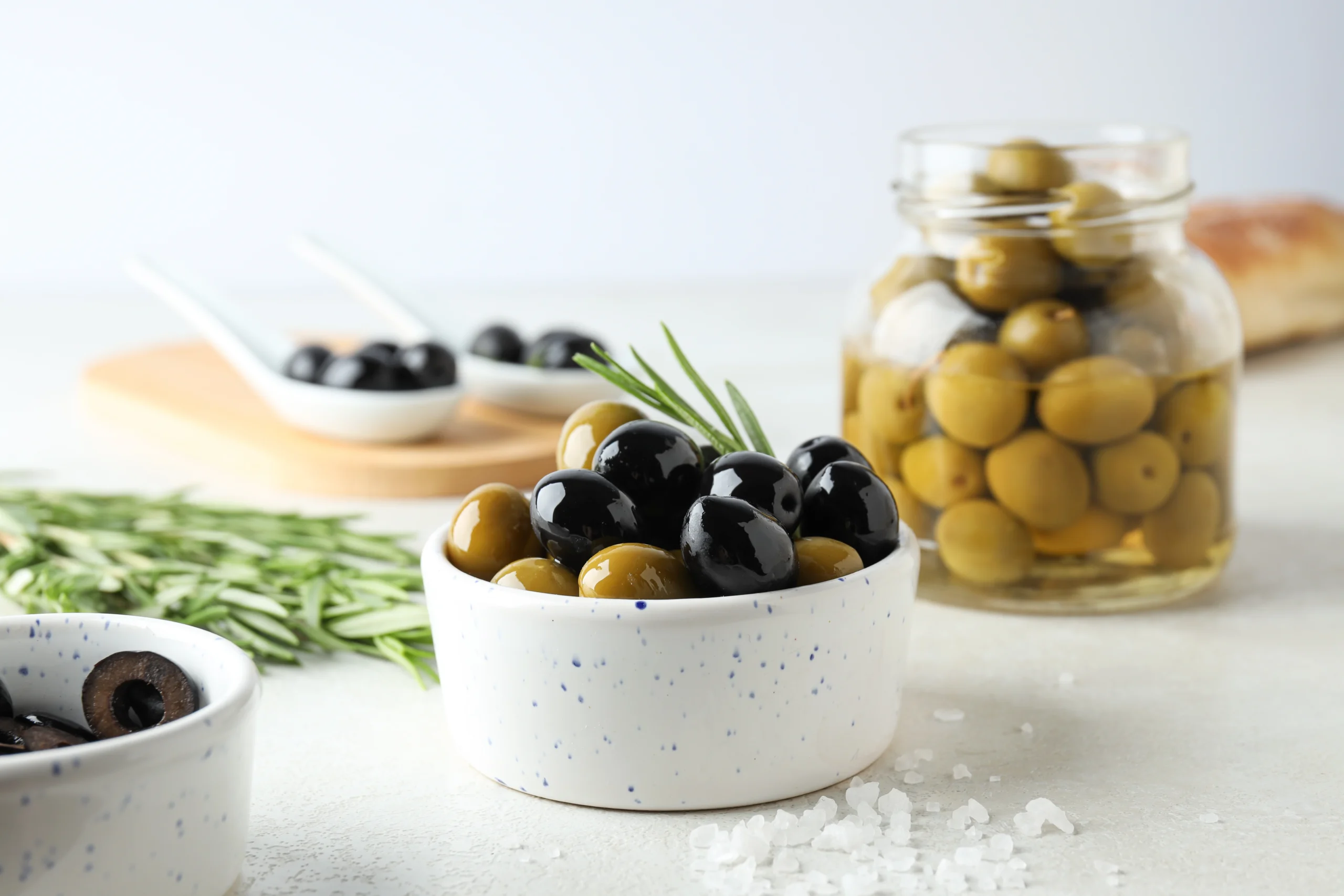Preparing fresh black and green olives perfect for salads, pizzas, and Mediterranean dishes.