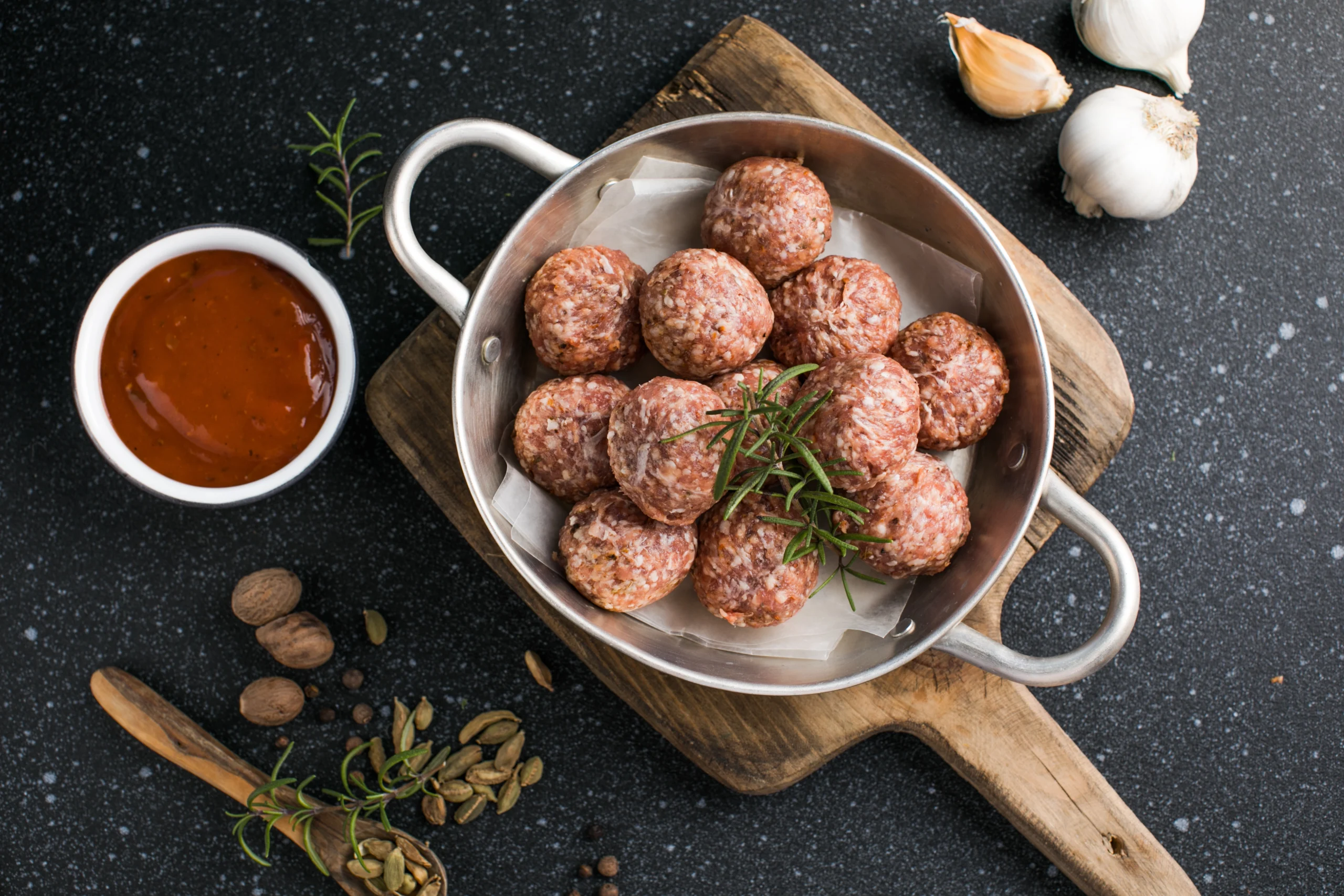 Freshly prepared halal meatballs with herbs and seasoning, ready to cook for a flavorful meal.